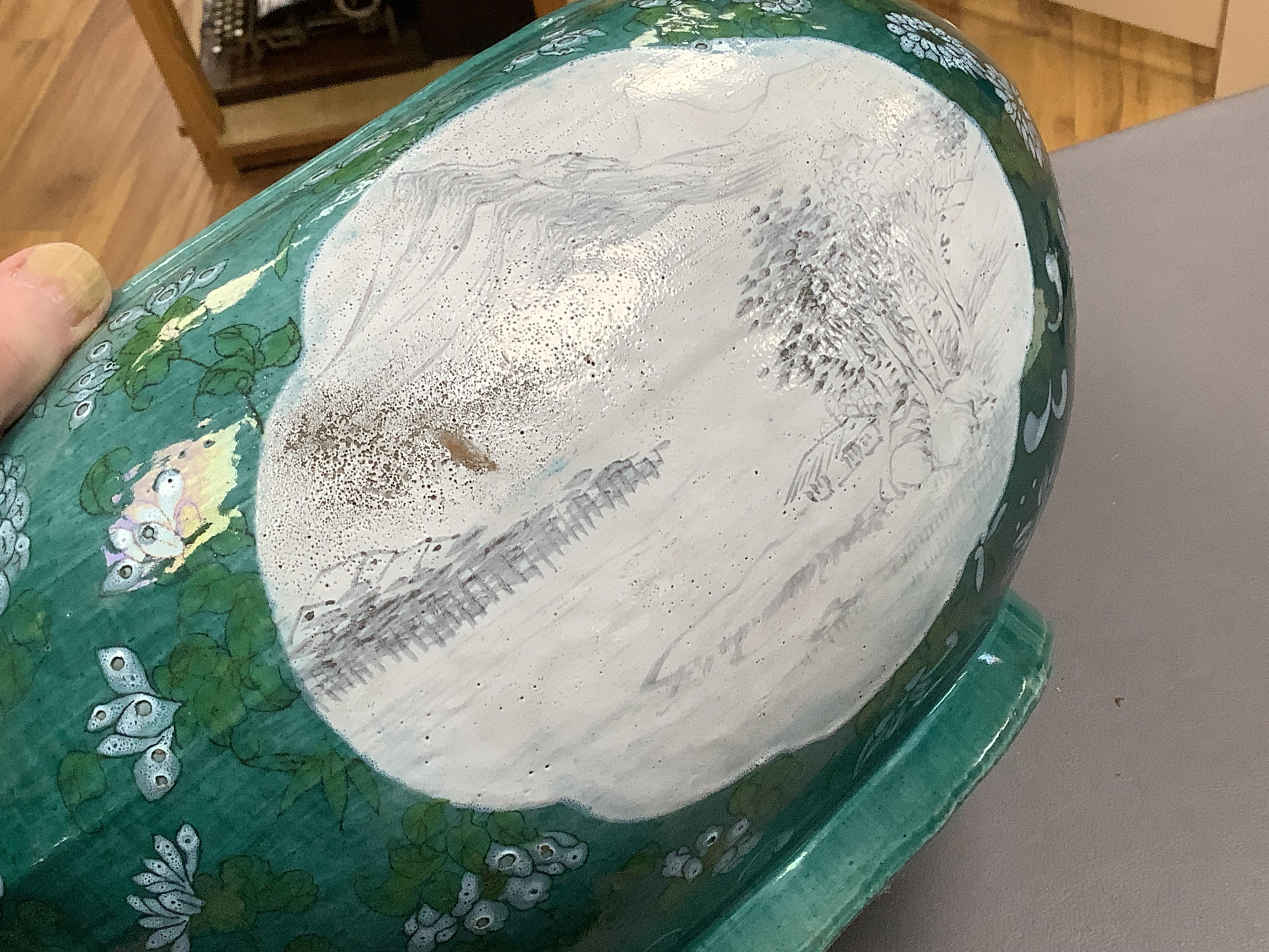 A Chinese enamelled porcelain oval bowl, Guandong kilns, early 20th century, green with en grisaille panels, 20cm high